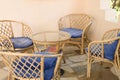 Wicker wooden chairs and coffee table for relaxing and socializing with family or friends on the outdoor village terrace of the ho Royalty Free Stock Photo