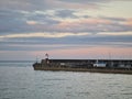 Wicklow lighthouse and harbor at sunset , Ireland Royalty Free Stock Photo