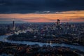 Wide aerial panorama of the illuminated London skyline during evening Royalty Free Stock Photo