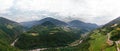 Wide aerial view of the alpine vineyards on a summer day. flat rows of fields, small village of Faver, famous for wine production Royalty Free Stock Photo