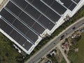 Wide aerial view of a massive building with solar panels installed on the entire roof at Cavite Export Processing Zone in Rosario Royalty Free Stock Photo