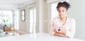 Wide angle of beautiful african american woman with afro hair Pointing aside worried and nervous with forefinger, concerned and Royalty Free Stock Photo