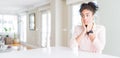 Wide angle of beautiful african american woman with afro hair Tired hands covering face, depression and sadness, upset and