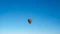 wide angle capture of hot air balloon on blue background in the sky Royalty Free Stock Photo
