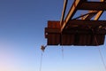 Rope access worker inspector wearing fall safety harness working abseiling in rope transfer position