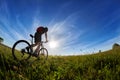 Wide angle of the cyclist with mountain bicyclist against beautiful landscape. Royalty Free Stock Photo