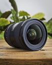 Wide angle DSLR lens on a wooden table Royalty Free Stock Photo