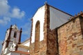 Wide angle on the external facade of the Cathedral Se of Silves, Algarve, with white storks nesting at the top