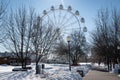 A wide-angle, horizontal shot of a large, urban Ferris wheel.