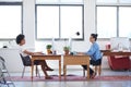 Creative space for contemporary business. Wide angle image of two female creative professionals in an open plan office