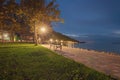 Wide angle landscape view of evening in Lake Balaton. Plane-tree alley with illuminated by street lanterns Royalty Free Stock Photo