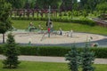 Wide-angle landscape view of modern children playground with rope net in the city park.