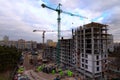 Wide-angle landscape view of typical construction site with two high cranes in big city. Modern concrete structure Royalty Free Stock Photo