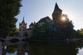 Wide angle landscape view of Vajdahunyad Castle. City Park of Budapest, Hungary. Sun beams shining, bright flash Royalty Free Stock Photo