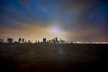 Wide angle night photo of a city with storm approaching moody sky Royalty Free Stock Photo
