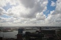 Wide angle overview at 100 metres height over the Rotterdam Skyline with blue sky and white rain clouds Royalty Free Stock Photo