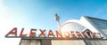 Wide angle panorama of Alexanderplatz sign at railway and subway station with tv tower behind - Side view of world famous landmark