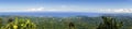 Wide Angle Panoramic Landscape View of Baracoa Bay and Atlantic Ocean Coastline from summit of El Yunque Mountain Cuba Royalty Free Stock Photo
