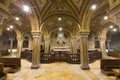 Wide angle photo of a crypt Inside catholic church with soft lighting