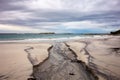 Wide angle photo of a dry wiver with a black sand on a beach in Western Australia