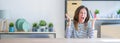 Wide angle photo of middle age senior woman sitting at the table at home celebrating crazy and amazed for success with arms raised Royalty Free Stock Photo