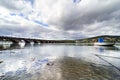Wide angle photo of the stone bridge spanning the bay of Pontedeume in La Coruna, Spain with mountains with houses and a boat in Royalty Free Stock Photo