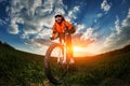 Wide angle portrait against blue sky of mountain biker Cyclist