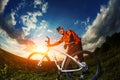 Wide angle portrait against blue sky of mountain biker Cyclist