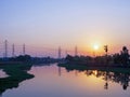 Wide angle scenic of twilight sky with  electricity transmission tower and reflection on water in river Royalty Free Stock Photo