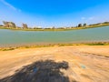 Wide angle shot of the bank of Mekong River and the Phnom Penh skyline against a clear blue sky Royalty Free Stock Photo