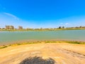 Wide angle shot of the bank of Mekong River and the Phnom Penh skyline against a clear blue sky Royalty Free Stock Photo