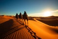 Wide angle shot of a camel caravan crossing Sahara Deserts sand dunes Royalty Free Stock Photo