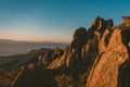 Wide angle shot of a cliff on a mountain under the sun and a clear blue sky Royalty Free Stock Photo