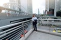 Wide angle shot of confident young Asian business woman looking on camera at urban city background. Royalty Free Stock Photo