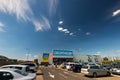 Wide angle shot , Decathlon store front, blue sky with white clouds.