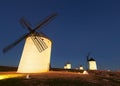 Wide angle shot of group of windmills in night