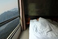 Wide angle shot of handsome young man sleeping comfortably in the bed with beautiful mountain nature morning view from windows Royalty Free Stock Photo