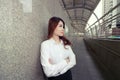 Wide angle shot of leadership young Asian business woman standing and looking confident against urban background. Royalty Free Stock Photo