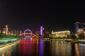 Wide angle shot of the lights of the city reflected over the water at night