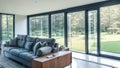 Wide-Angle Shot of Modern House Sunroom Living Area with Mid-Century Minimalistic Interior Design and Open Concept Layout . Royalty Free Stock Photo