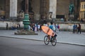 Wide angle shot of a person riding a bicycle on the street of the city