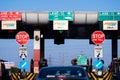 wide angle shot of toll booth in india with the Fast tag FASTag signs on all lanes showing the mandatory new RFID based
