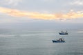 Wide angle shot of two ships sailing across the ocean under a cloudy sky Royalty Free Stock Photo