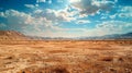 Wide angle shot of a vast desert landscape under a clear blue sky with white clouds Royalty Free Stock Photo