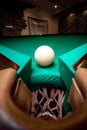 Wide angle shot white ball in billiard pocket