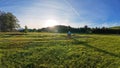 Wide angle shot of a woman cycling in the backlight of the sun Royalty Free Stock Photo