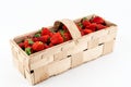 Wide angle shot of a wooden box full of red ripe strawberries isolated on white background. Harvesting summer fruits Royalty Free Stock Photo