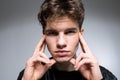 Wide angle. Studio shot. Young caucasian guy model in black clothes posing in the studio. Teenager in Leather Jacket Standing at Royalty Free Stock Photo