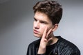 Wide angle. Studio shot. Young caucasian guy model in black clothes posing in the studio. Teenager in Leather Jacket Standing at Royalty Free Stock Photo