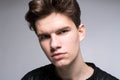 Wide angle. Studio shot. Young caucasian guy model in black clothes posing in the studio. Teenager in Leather Jacket Standing at Royalty Free Stock Photo